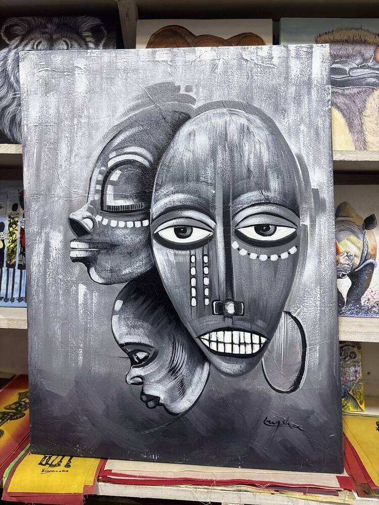 Black and white painting of traditional African masks by Tanzanian artist Lugsha