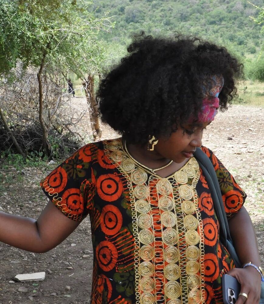 E'Layjiah in Tanzania wearing traditional dress
